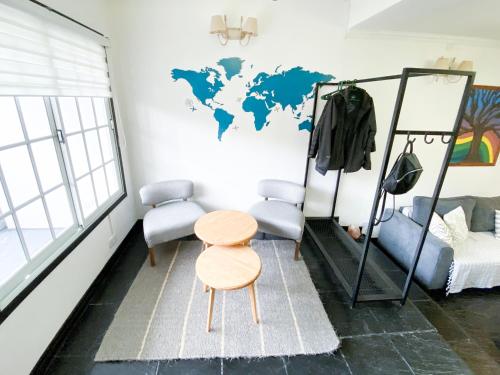 a room with a table and a map of the world on the wall at ESTRELLA POLAR - CASA in Ushuaia