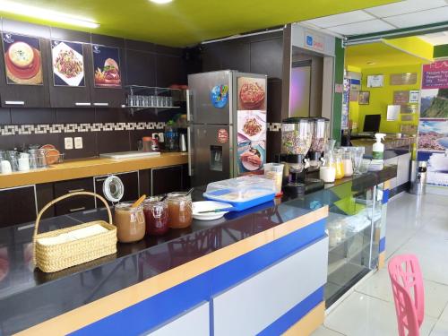 a restaurant with a counter with food on it at Hostal NAVAL in La Paz