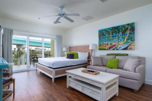 a living room with a bed and a couch at Harbour House at the Inn 316 in Fort Myers Beach