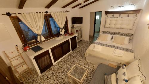 an aerial view of a bedroom with a bed and a desk at Mitzela Mare House in Amaliapoli