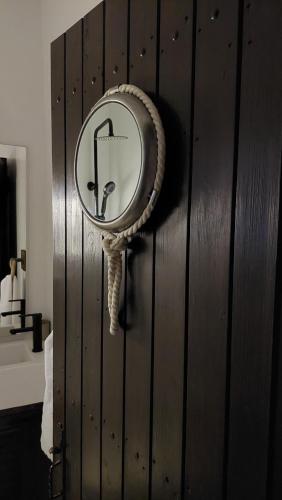 a mirror on the wall of a bathroom at Mitzela Mare House in Amaliápoli