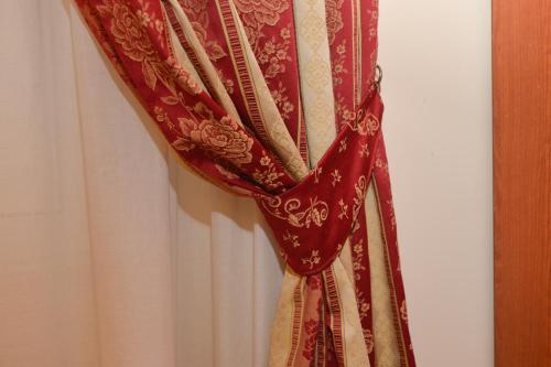 a red curtain is hanging on a wall at Hotel Chicago in Rome