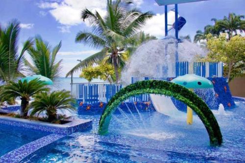 a pool at a resort with a water slide at Grand Diamond Beach, Dep 2 dormitorios in Tonsupa