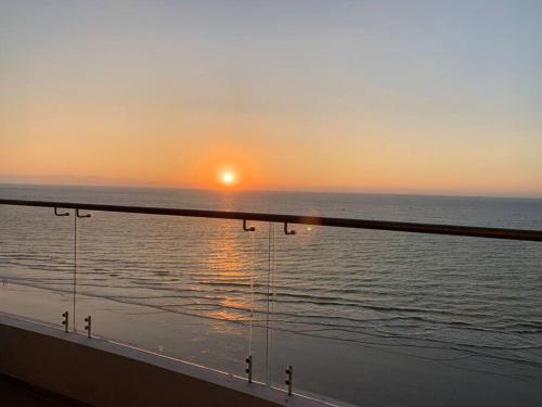 a view of the ocean at sunset from a cruise ship at Grand Diamond Beach, Dep 2 dormitorios in Tonsupa