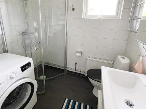 La salle de bains est pourvue de toilettes et d'un lave-linge. dans l'établissement Holiday home Torhamn II, à Torhamn