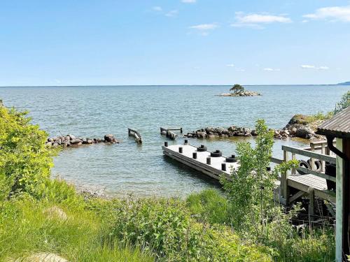 a dock in a body of water with rocks in it at 8 person holiday home in BRÅLANDA-By Traum in Brålanda