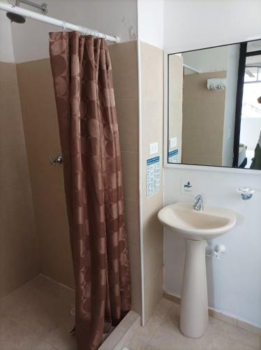 a bathroom with a shower curtain and a sink at Alojamiento Turístico Verano Azul San Andrés in San Andrés