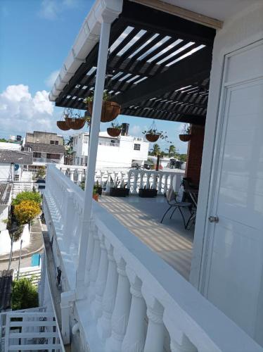 a balcony with a white railing and awning at Alojamiento Turístico Verano Azul San Andrés in San Andrés