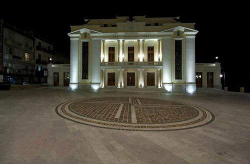 a large white building with a clock in front of it at Abruzzo Holiday in Ortona