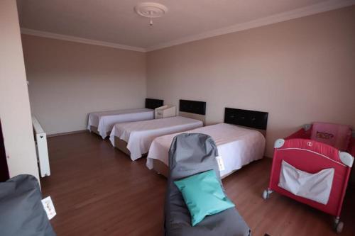 a room with three beds and a couch in it at Hancı Village KaŞ in Trabzon
