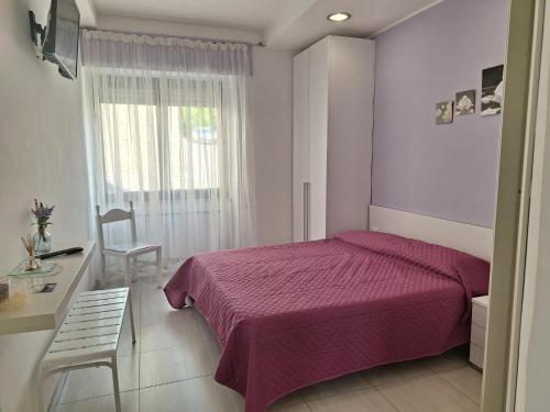 Ένα ή περισσότερα κρεβάτια σε δωμάτιο στο La Casa Dei Fiori