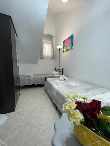a bedroom with a bed with flowers on it at Comfy Myrvalis Apartment in Agia Triada