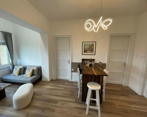 a living room with a table and a couch at Sea Flower apartment Rijeka in Rijeka