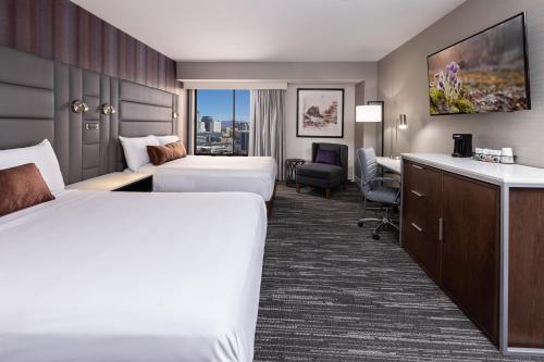a hotel room with two beds and a desk at J Resort in Reno