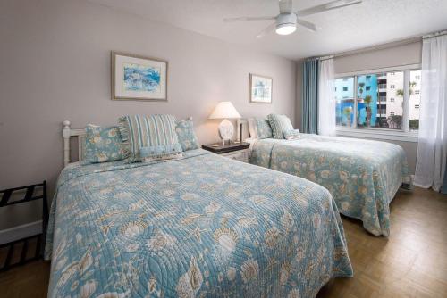 a bedroom with two beds and a window at Seaspray Condos 206B in Fort Walton Beach