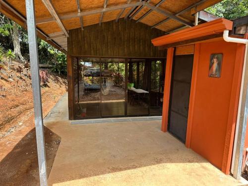 an open door of a house with a patio at Rincón de Goye in Turrialba