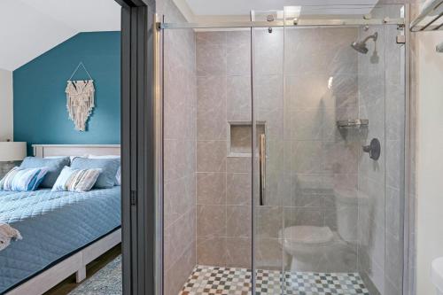 a shower with a glass door in a bedroom at Terlingua at the Bend in Wimberley