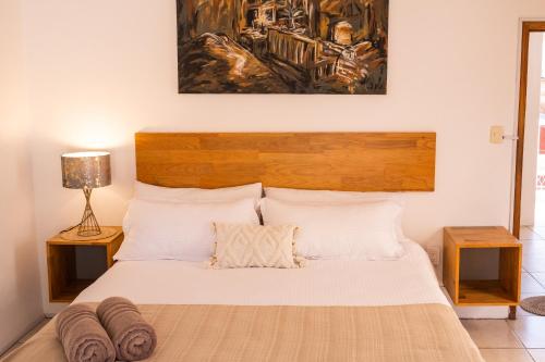 a bedroom with a bed with a wooden headboard at Spacious artsy home with fast WiFi in Oaxaca City