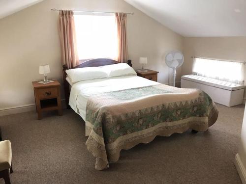 a bedroom with a large bed and a window at Kenns Farm - 2 Beautiful Barns in Carterton