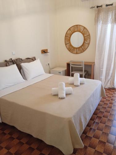 a bedroom with a large bed with towels on it at Castro Hotel in Monemvasia