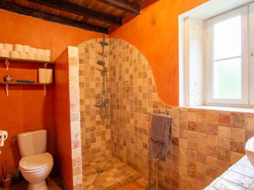 an orange bathroom with a shower and a toilet at Maison périgourdine avec piscine privée chauffée, cheminée et jardin clôturé - Animaux bienvenus - FR-1-616-302 in Mareuil
