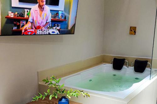 a bath tub with a tv on the wall at Luxury Home In Aguacatala in Medellín
