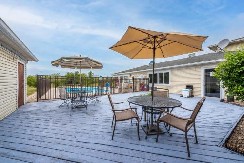 a patio with tables and chairs and umbrellas at American Inn & suites in Dundee