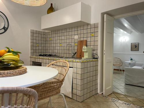 a kitchen with a table and a counter top at Ortigia_corte d'avolio in Siracusa