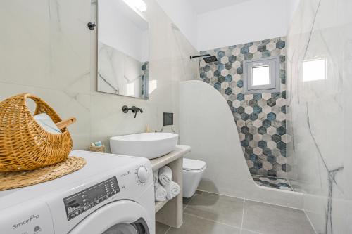 a bathroom with a washing machine and a sink at Zana's Villa-Sandra in Akrotiri