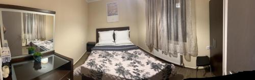 a small bedroom with a bed and a mirror at VILA MARIALENA in Petropiyí