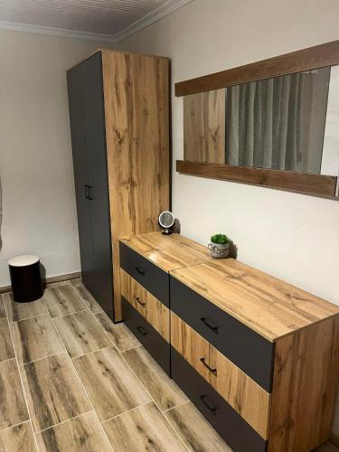 a bedroom with a wooden dresser and a shelf at VILA MARIALENA in Petropiyí