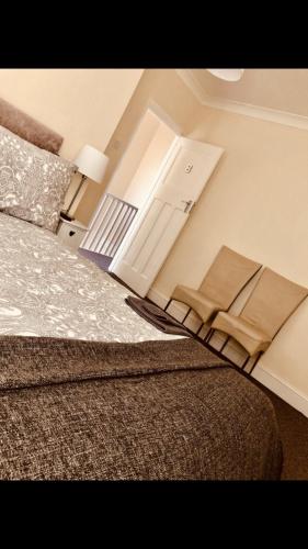 a bedroom with a bed and a door with towels on it at Ac lounge36 (B) in Rochford