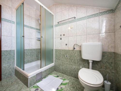a bathroom with a toilet and a glass shower at Apartments Vladimir in Vodice