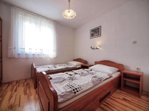 a bedroom with two beds and a window at Apartments Vladimir in Vodice