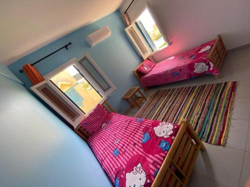 einen Blick über ein Schlafzimmer mit 2 Betten in der Unterkunft علاء الدين 104 قرية مينا 4 الكيلو 74 in Dawwār ‘Abd al ‘Aţī Abū ‘Ajūz