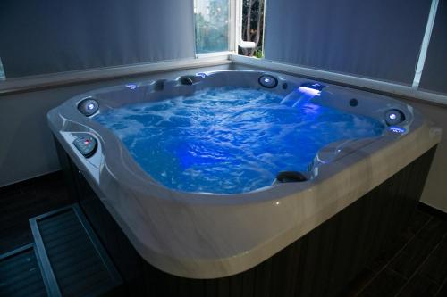 a blue tub in a room with a window at Ted's Luxury Place with jacuzzi in Šibenik