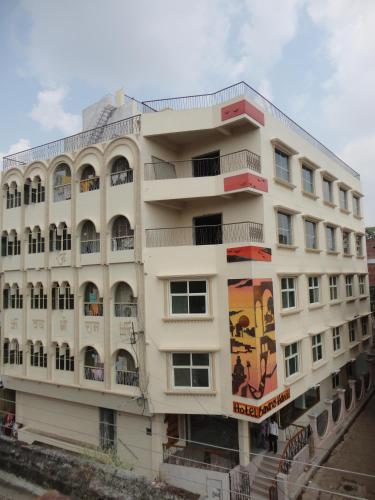 a white building with a mural on the side of it at Hotel Banaras Haveli in Varanasi