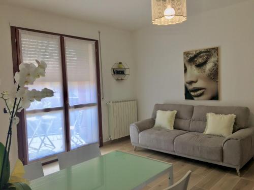 a living room with a couch and a glass table at Appartamento BELVEDERE in Castiglione Olona