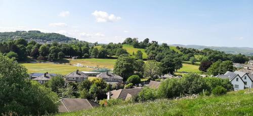 a small town with houses and a green field at Castle Cottage in Kendal