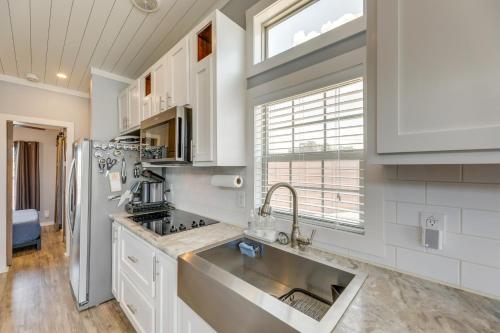 a kitchen with a sink and a refrigerator at Austin Tiny Home with Community Pool and Hot Tub! in Austin