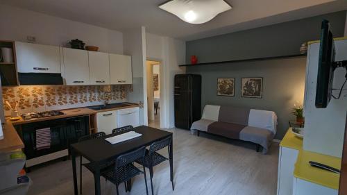 a kitchen with a table and a room with a bed at Splash House in Tirrenia