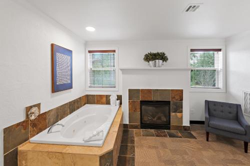 a large bathroom with a tub and a fireplace at Best Western Wesley Inn & Suites in Gig Harbor