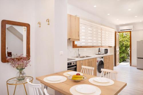 a kitchen with a wooden table and a dining room at Fiera Luxury Apartments. in Kokkari