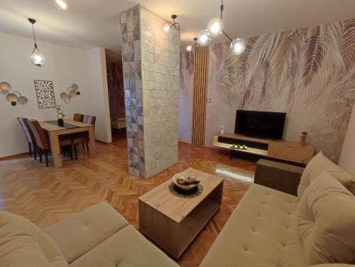 a living room with a couch and a tv at High T in Kraljevo
