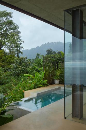 a swimming pool in a house with a view at ACHIOTÉ Architectural Gem - Adults Only in Uvita