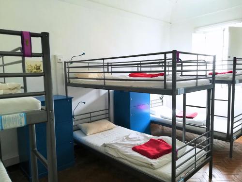 een kamer met 3 stapelbedden in een kamer bij Old Évora Hostel in Évora