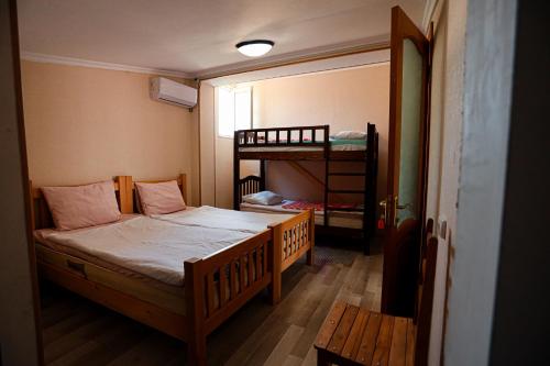 a bedroom with a bed and a bunk bed at Guesthouse Gua in Kutaisi