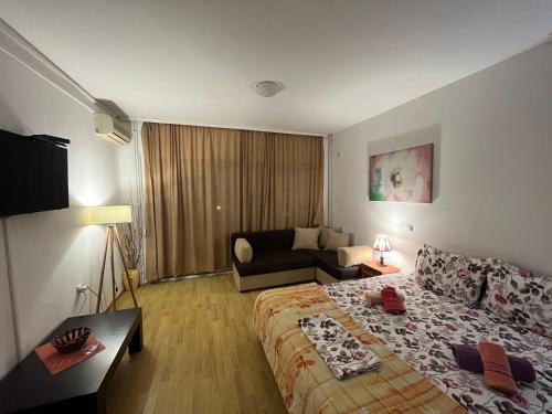 a hotel room with a bed and a couch at Apartments Baja in Ulcinj