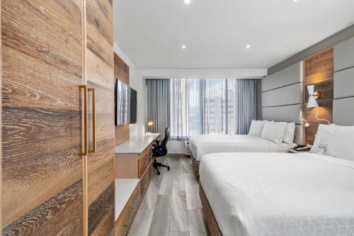 a hotel room with two beds and a tv at Holiday Inn Express San Juan Condado, an IHG Hotel in San Juan