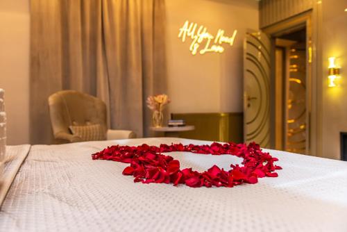 a bed with a bunch of red roses on it at Alexandras Palace in Bradford